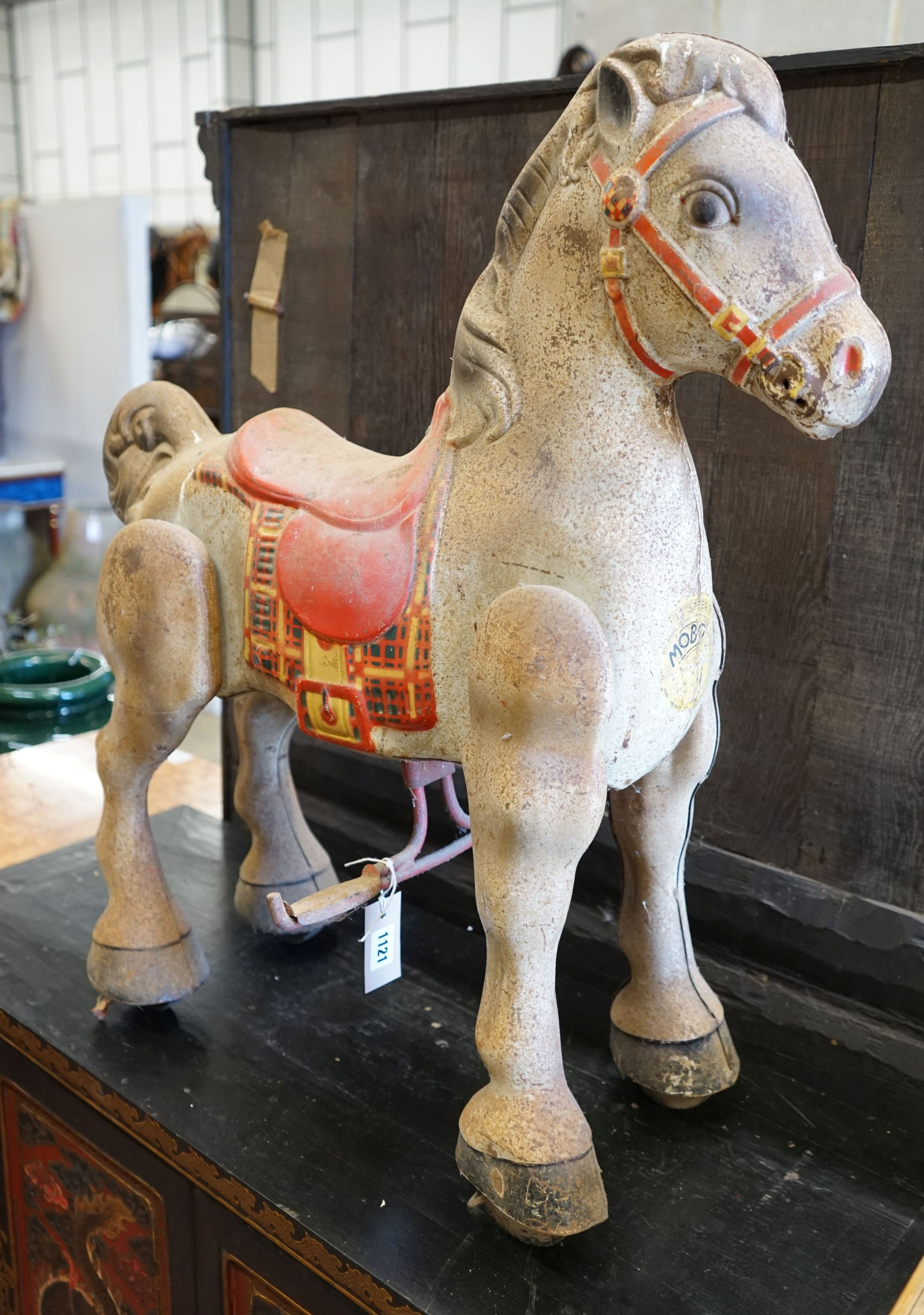 A vintage Mobo painted tinplate toy sit on horse, length 66cm